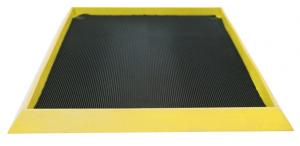 A specialised black cleaning mat called the Boot Dip Mat is shown alone. It has a yellow border that is considerably raised.