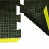 A close up of the bubble anti fatigue mat suction cups to stick it to the floor and a bevelled yellow safety border.