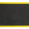 A single middle tile from the modular anti fatigue bubble mat is shown alone. It has a black surface with bubbles and a yellow safety border.