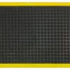 A single edge tile from the modular anti fatigue bubble mat is shown alone. It has a black surface with bubbles and a yellow safety border.