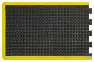 A single edge tile from the modular anti fatigue bubble mat is shown alone. It has a black surface with bubbles and a yellow safety border.