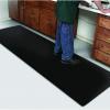 the diamond foot anti fatigue mat is laid under a mans feet as he works at a bench with draws either side