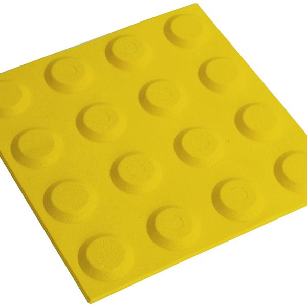 A yellow tactile has raised lumps to help blind or visually impaired people navigate.