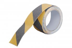 A roll of anti slip tape is shown alone. It is yellow and black striped and has a textured surface to provide slip resistance.