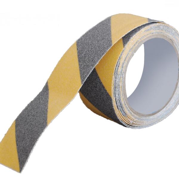 A roll of anti slip tape is shown alone. It is yellow and black striped and has a textured surface to provide slip resistance.