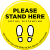 A yellow Floor Sticker reads "Please Stand Here. Social Distancing". It shows two feet to indicate where to stand.