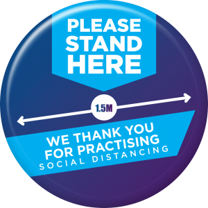 A Custom Printed Social Distancing Floor Sticker says "Please Stand Here We Thank You for Practising Social Distancing"