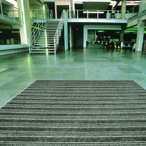 A green-tinged image of a commercial entrance fitted with the Master Scraper entrance mat. The mat is black and grey horizontal striped with raised strips in a lighter colour.