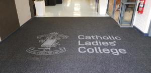 Catholic Ladies College logo on a tough scrape mat.