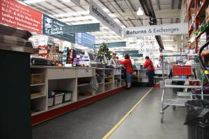 Behind the checkout counter at Bunnings Warehouse is fitted with a black anti fatigue mat - the Super Comfort - with a yellow safety border.