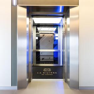 A lift mat is printed with the branding of La Riviere apartment block in the Gold Coast. The name and logo is printed in gold, the mat itself is charcoal and fitted into a lift floor.